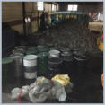 PCB impacted materials in barrels for disposal.